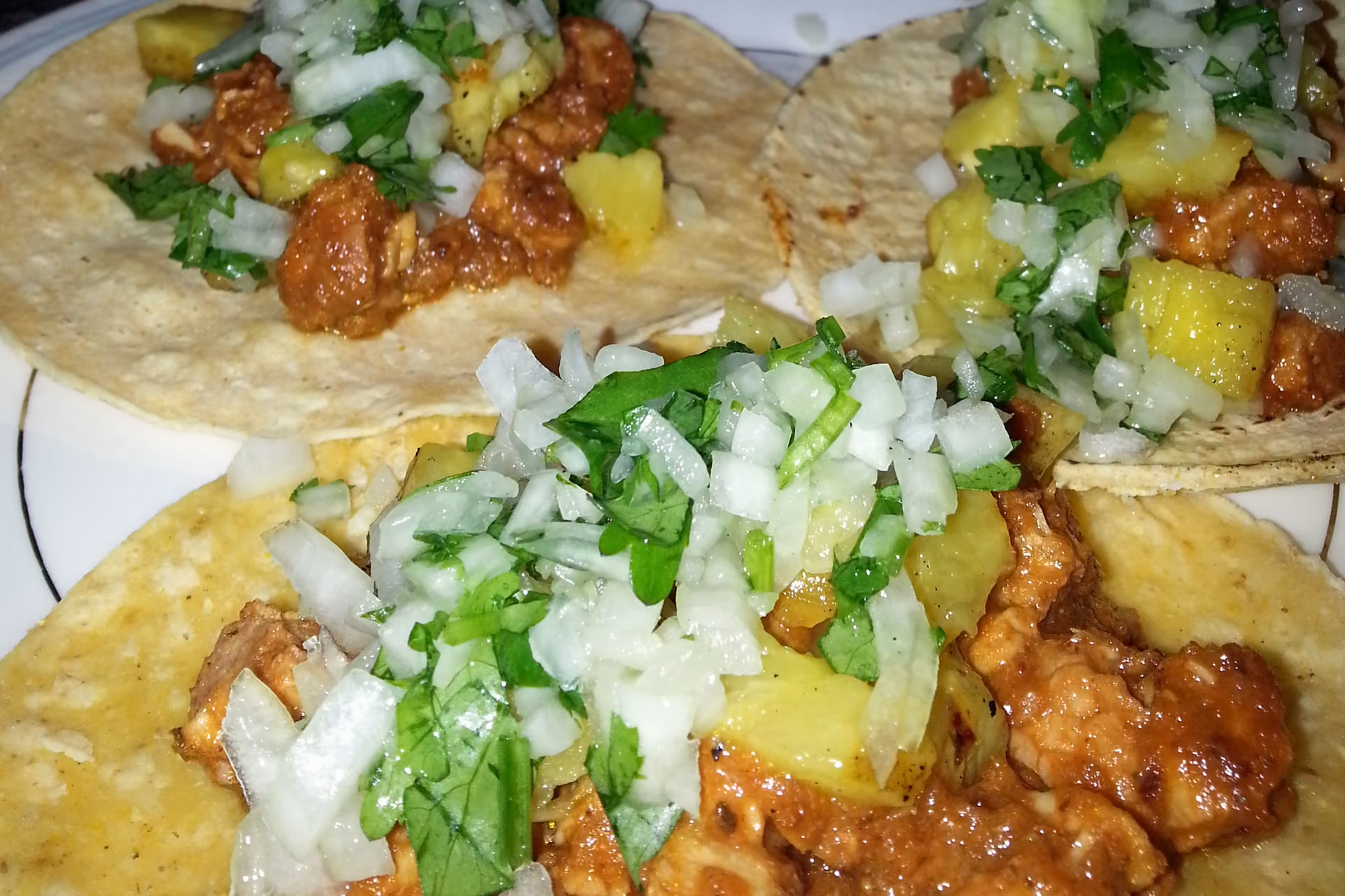 Demo sample photo: al pastor tacos topped with pineapple, onion and cilantro.